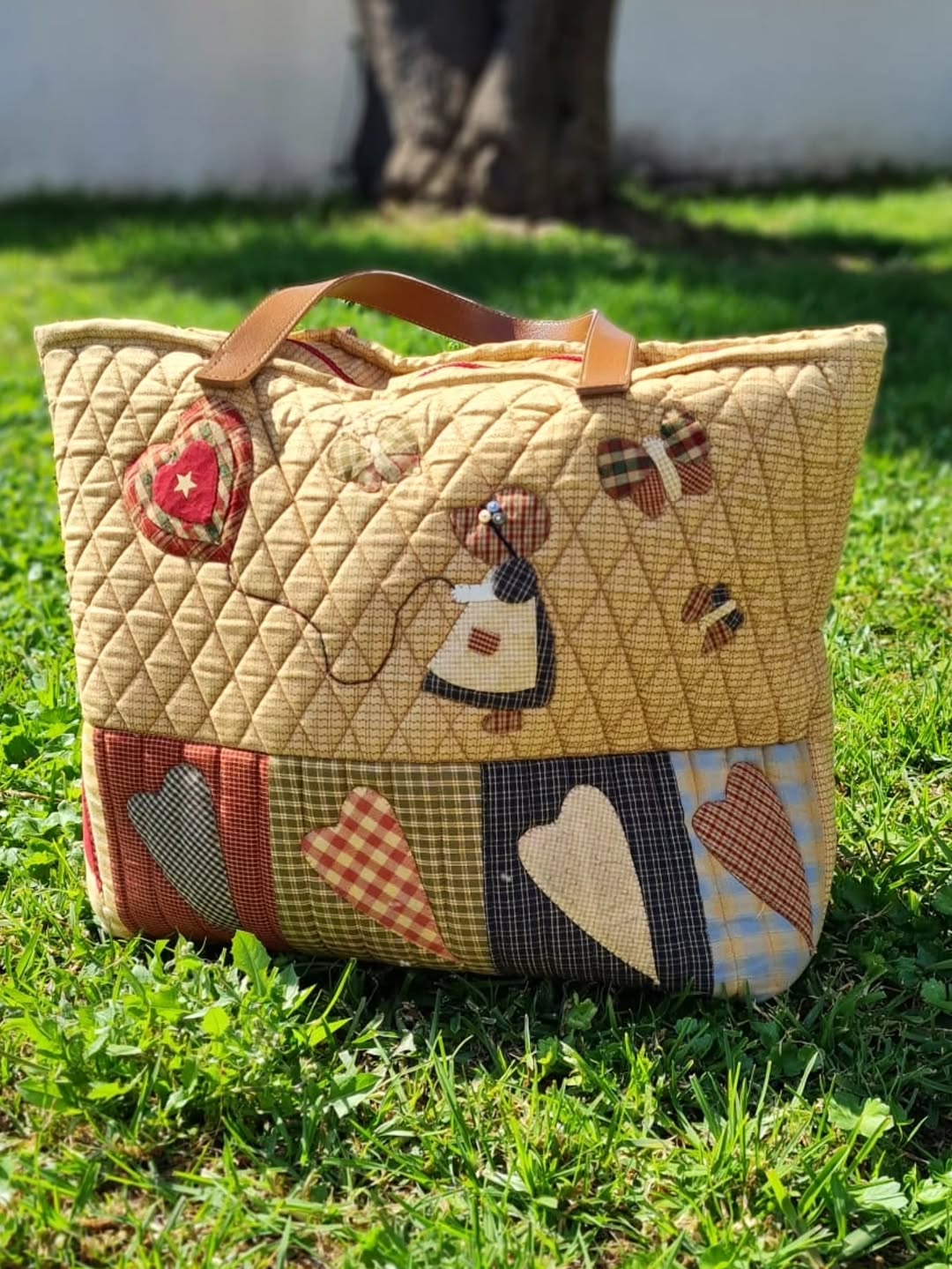 Bolso acolchado de patchwork con muñeca, corazones y mariposas aplicados a mano